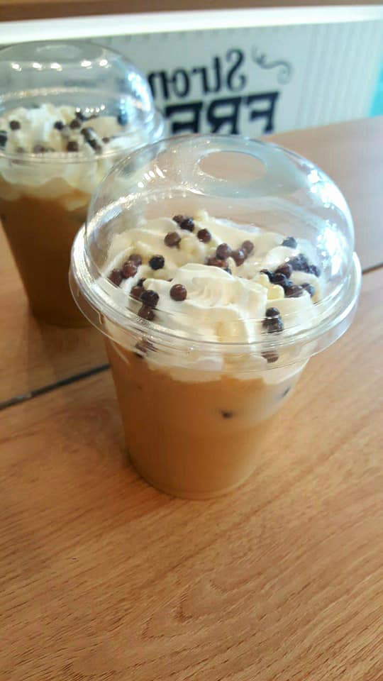 Iced coffee with whipped cream and chocolate pearls
