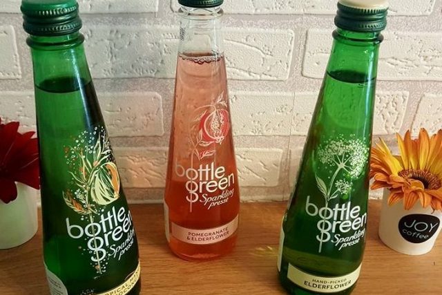 Three Bottlegreen bottles: tropical fruit, pomegranate and elderflower, elderflower
