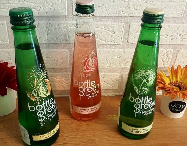 Three Bottlegreen bottles: tropical fruit, pomegranate and elderflower, elderflower